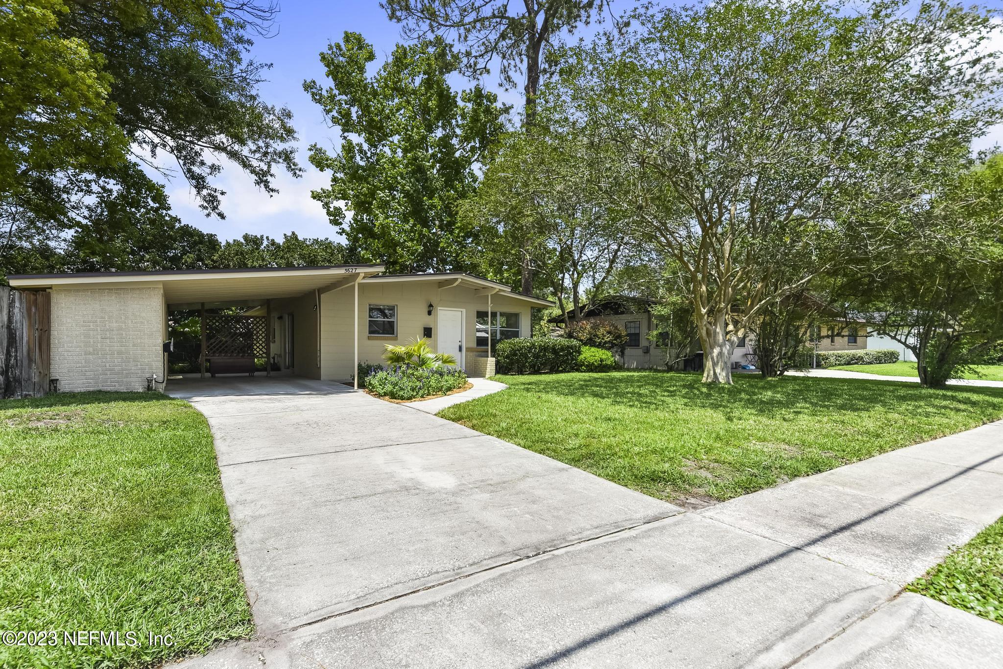 5627 Sabena Road Jacksonville, FL 32207 - Photo 2 of 22 front view of a house with a yard