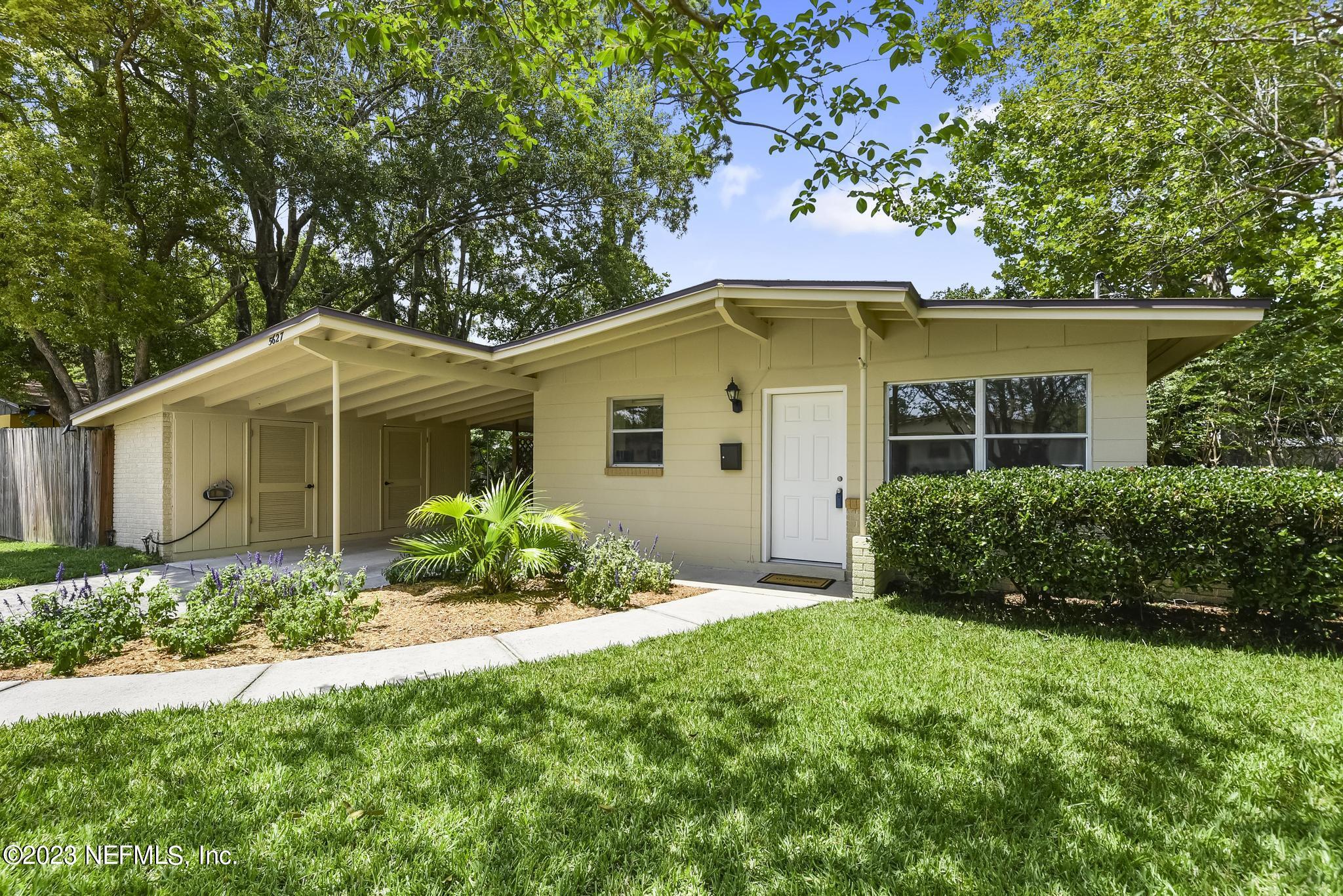 5627 Sabena Road Jacksonville, FL 32207 - Photo 3 of 22 a view of a house with a yard and potted plants