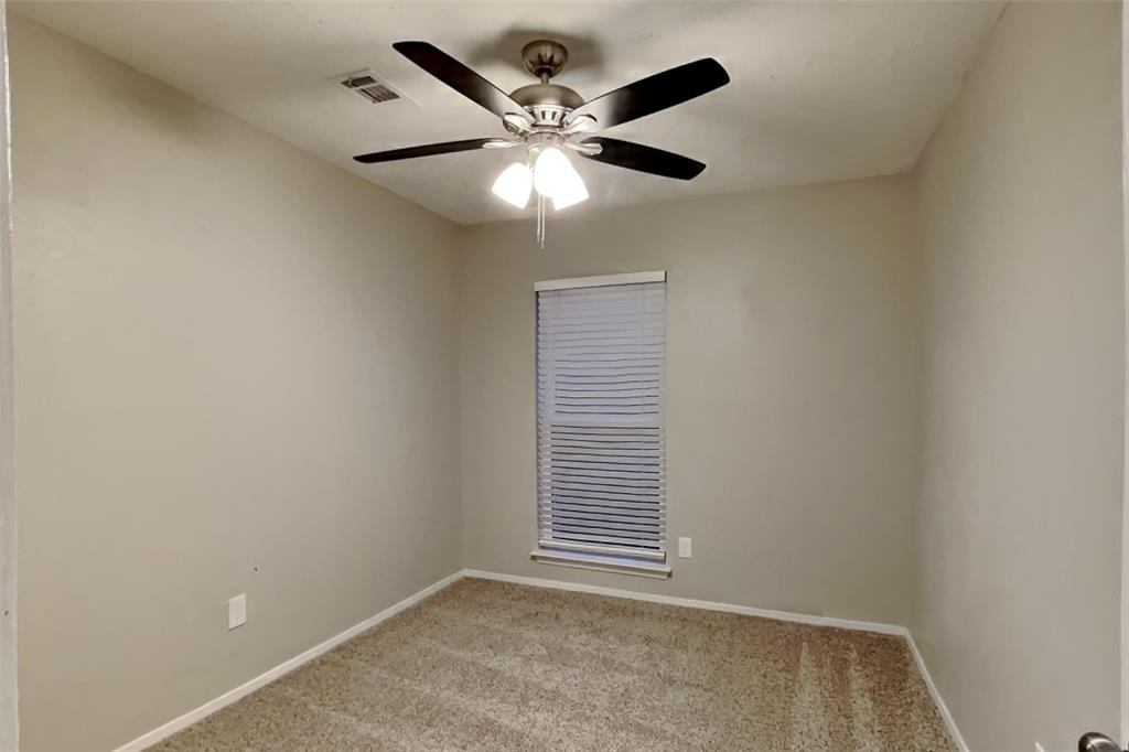2730 Naples Drive Garland, TX 75040 - Photo 11 of 18 an empty room with windows and fan