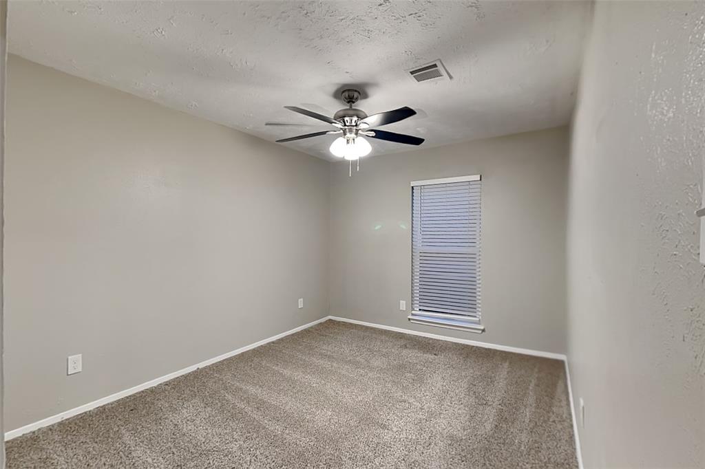2730 Naples Drive Garland, TX 75040 - Photo 14 of 18 a view of an empty room with a ceiling fan and window