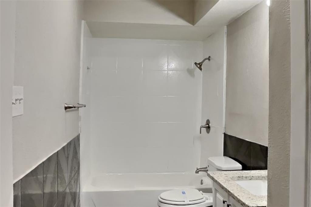 2730 Naples Drive Garland, TX 75040 - Photo 15 of 18 a bathroom with a sink a toilet and shower