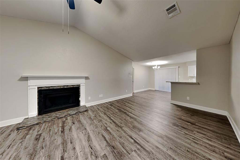 2730 Naples Drive Garland, TX 75040 - Photo 2 of 18 a view of empty room with wooden floor and fireplace