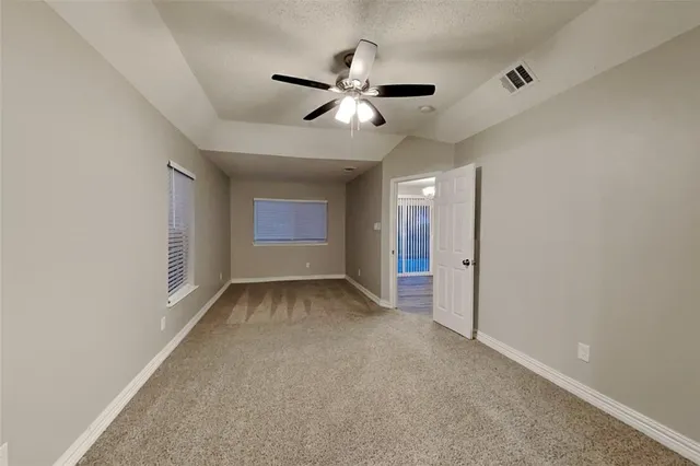 a view of an empty room with a ceiling fan