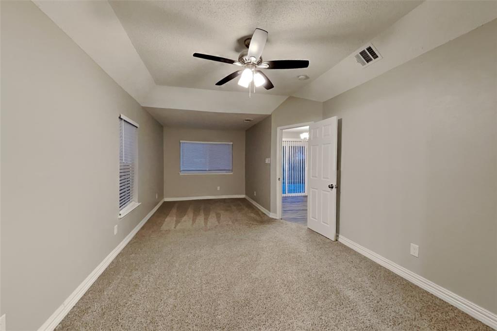 2730 Naples Drive Garland, TX 75040 - Photo 8 of 18 a view of an empty room with a ceiling fan