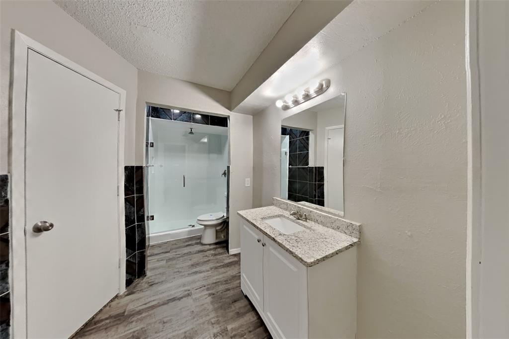 2730 Naples Drive Garland, TX 75040 - Photo 9 of 18 a bathroom with a granite countertop sink and a mirror