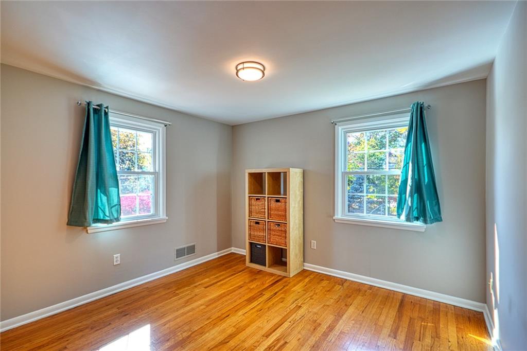 1608 Seegar Road Pittsburgh, PA 15241 - Photo 17 of 24 a view of an empty room with a window and wooden floor