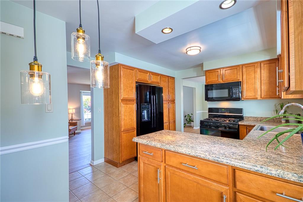 1608 Seegar Road Pittsburgh, PA 15241 - Photo 7 of 24 a kitchen with stainless steel appliances granite countertop a refrigerator a stove and a sink with granite countertops