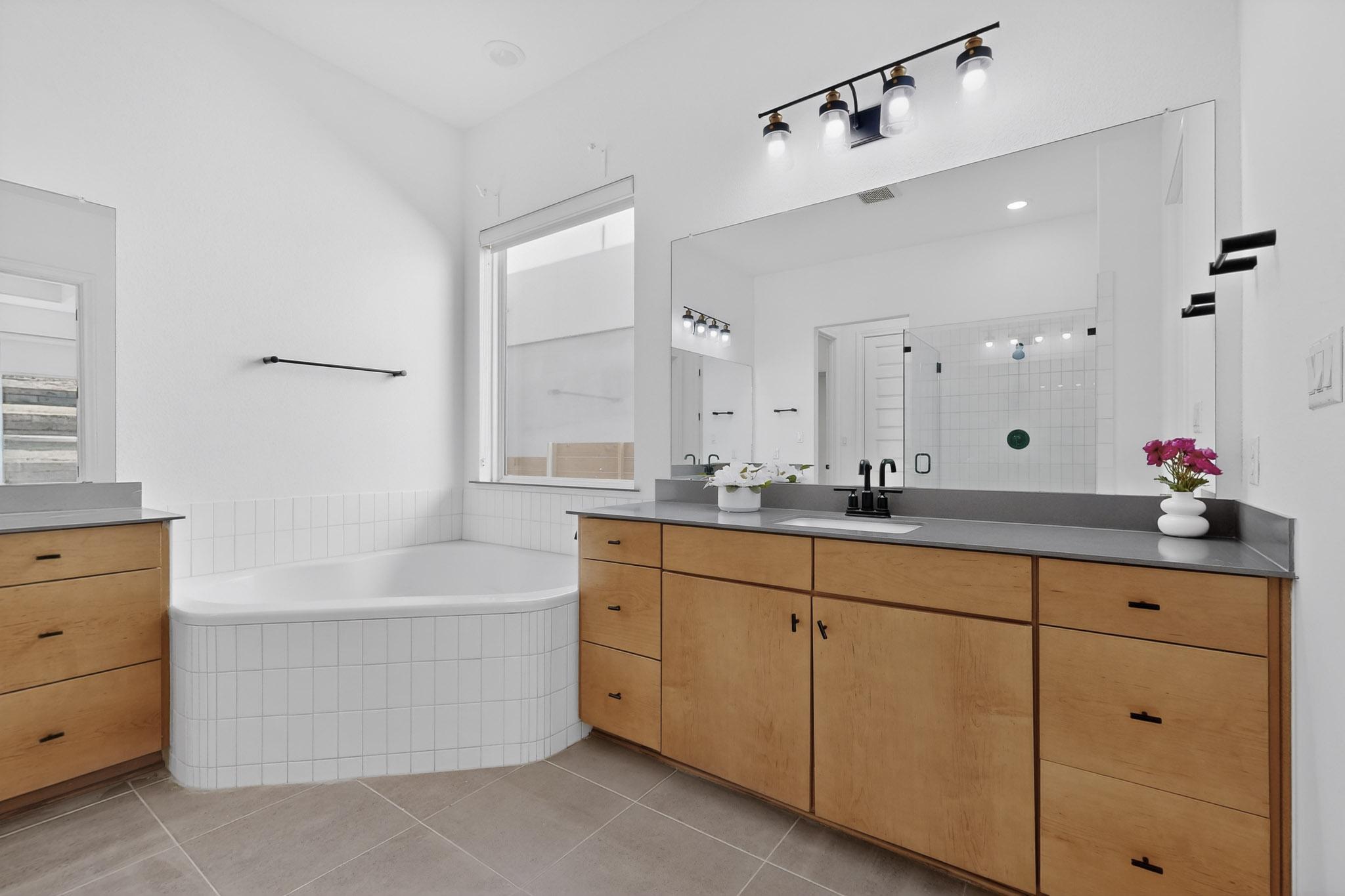 7705 Alouette Drive Austin, TX 78738 - Photo 19 of 40 a bathroom with a tub sink and mirror