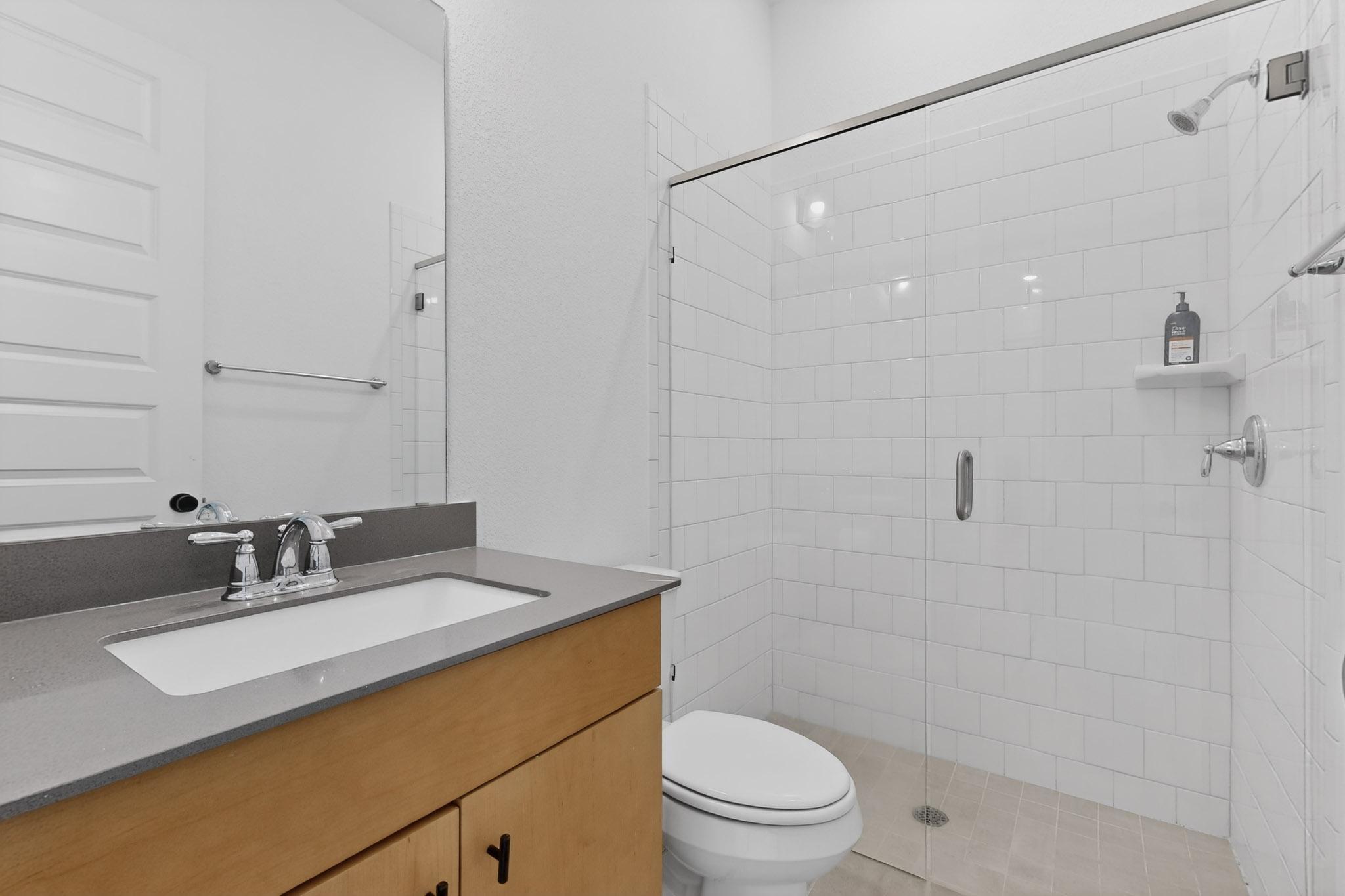 7705 Alouette Drive Austin, TX 78738 - Photo 23 of 40 a bathroom with a sink toilet vanity and shower