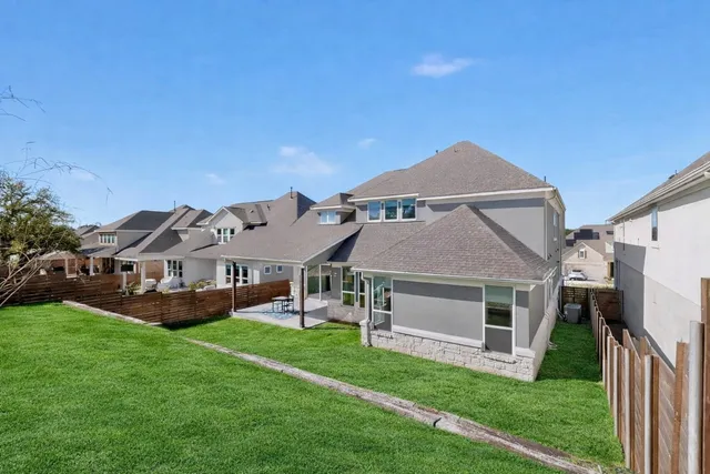 a view of a house with a yard and sitting area