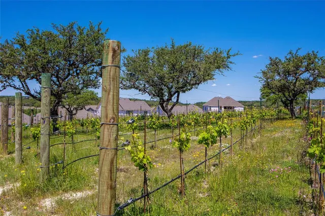a view of a roof deck with table and chairs with wooden floor and fence