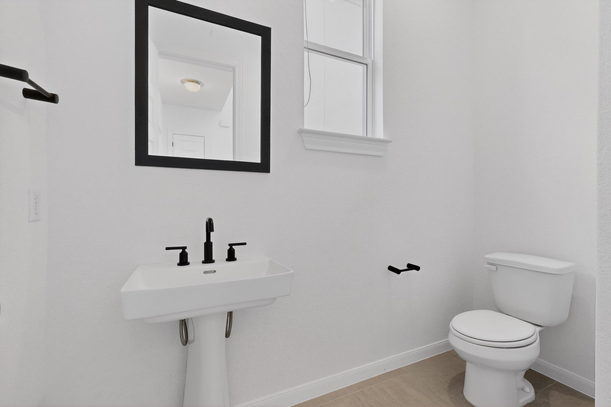 7705 Alouette Drive Austin, TX 78738 - Photo 6 of 40 a bathroom with a toilet sink and mirror