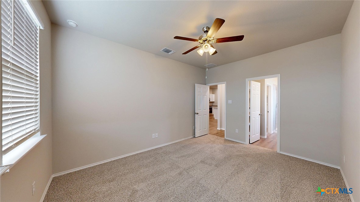 1110 Stone Vly Road Temple, TX 76502 - Photo 11 of 21 an empty room with windows and fan
