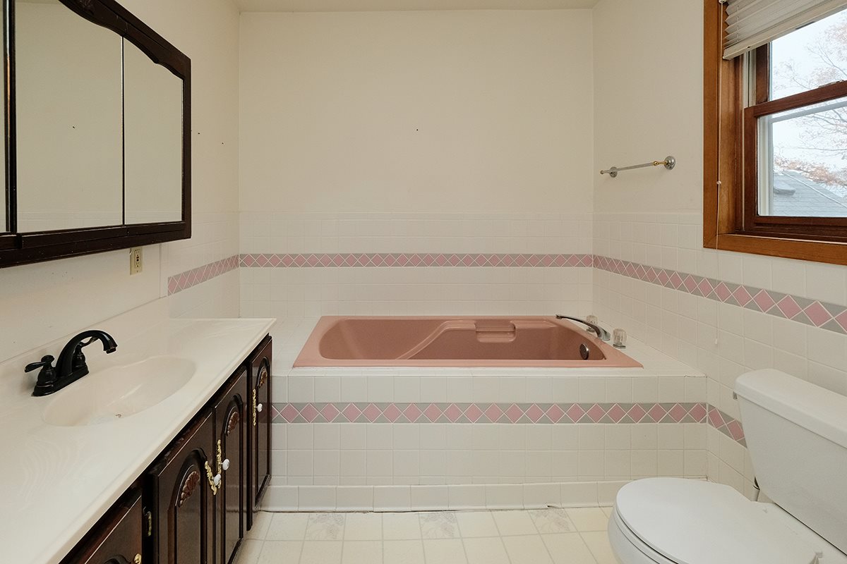 12331 Moate Road Durand, IL 61024 - Photo 9 of 25 a bathroom with a sink a toilet and mirror