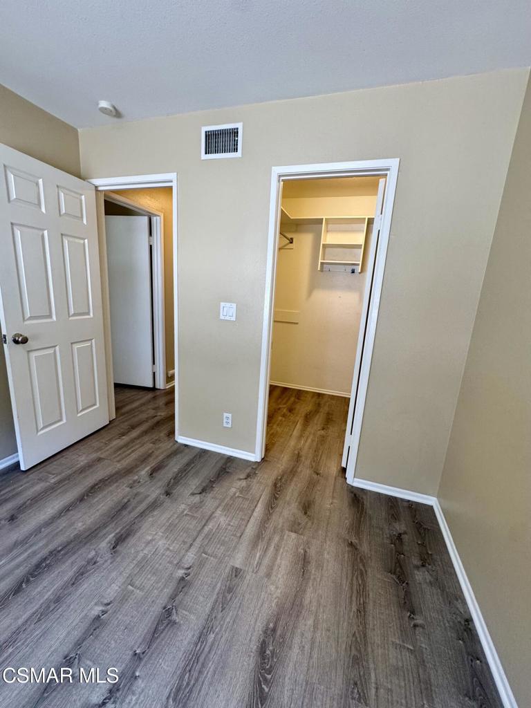 2014 Avenida Placida, Unit 4 Simi Valley, CA 93063 - Photo 11 of 12 an empty room with wooden floor and closet