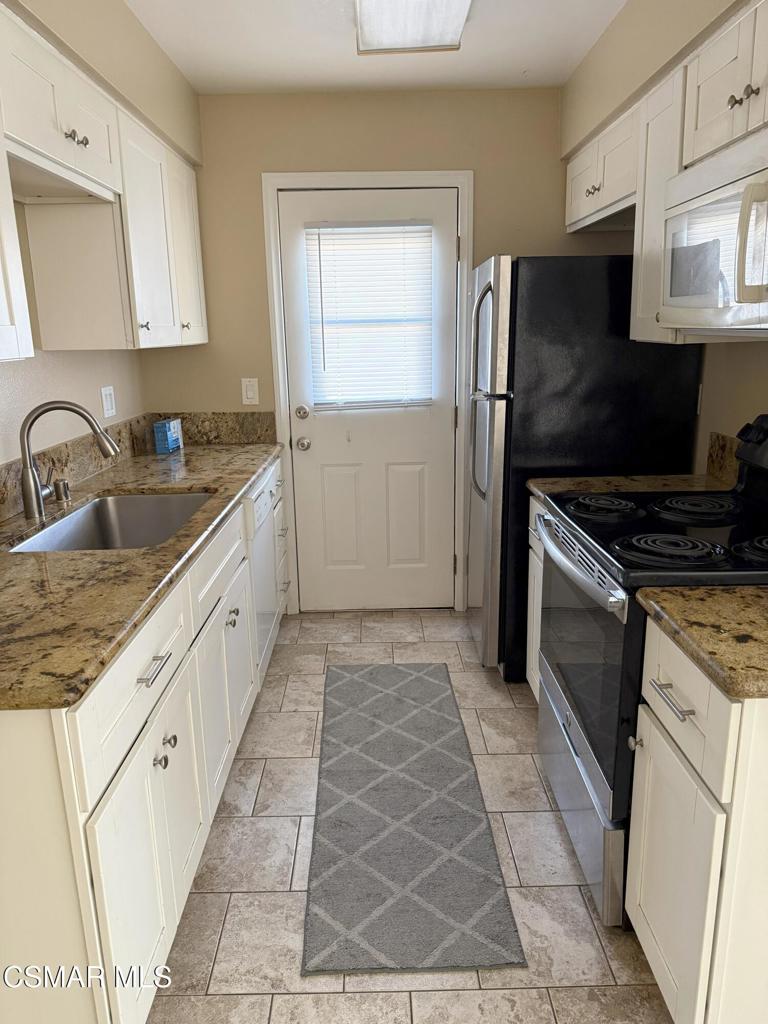 2014 Avenida Placida, Unit 4 Simi Valley, CA 93063 - Photo 2 of 12 a kitchen with granite countertop a refrigerator stove and sink