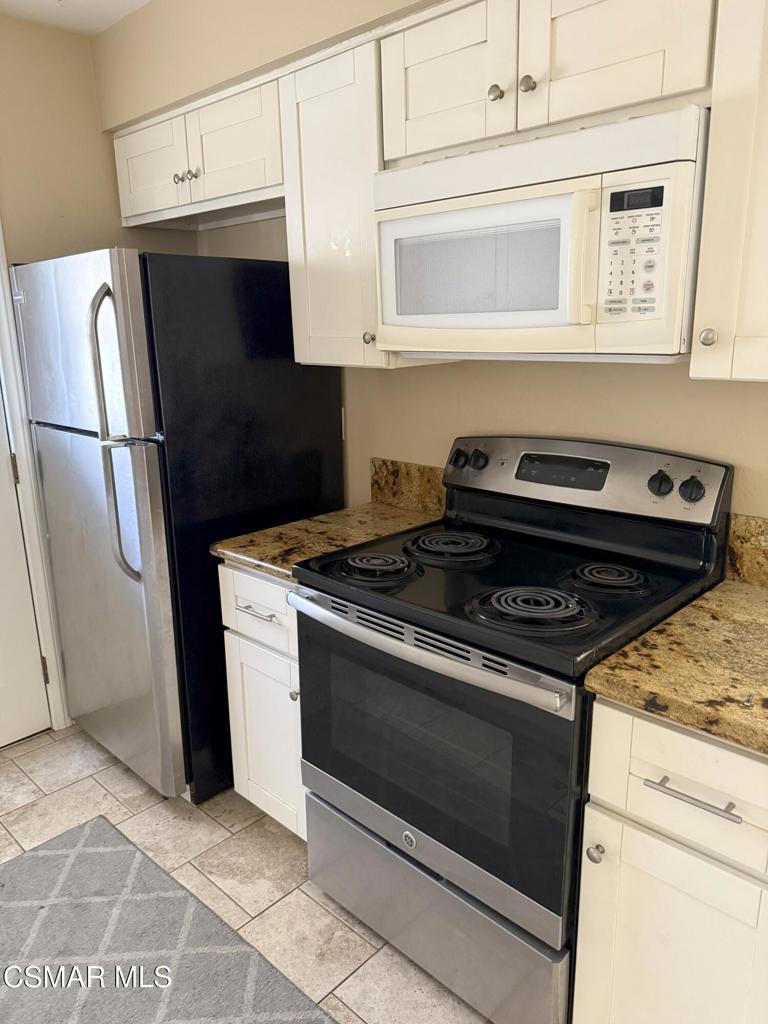 2014 Avenida Placida, Unit 4 Simi Valley, CA 93063 - Photo 3 of 12 a stove top oven sitting inside of a kitchen