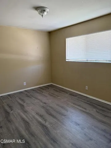 an empty room with wooden floor