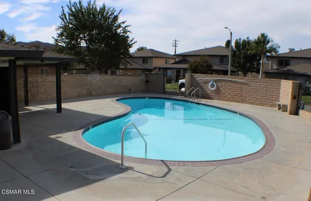 a view of a swimming pool with sitting area