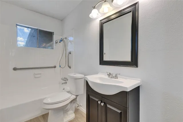 a bathroom with a sink a toilet and mirror