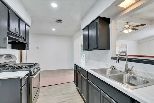 a kitchen with sink cabinets and stove