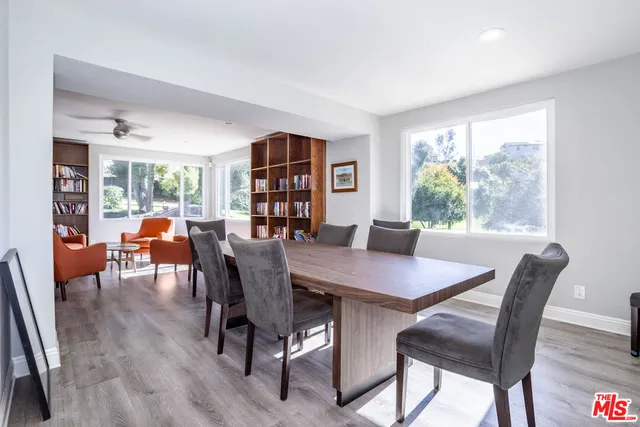 a living room with furniture a rug and a book shelf