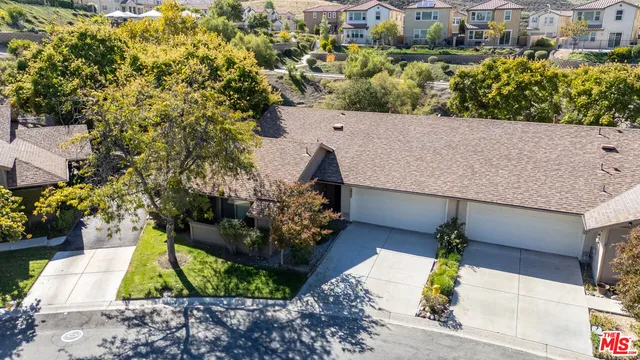 an aerial view of a house with a yard and garden