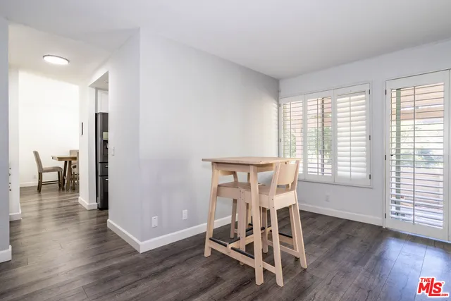 a dining room with furniture and wooden floor
