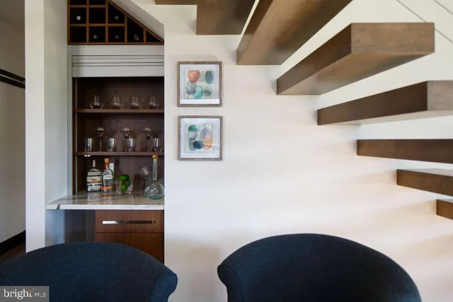 a living room with table mirror and cabinets