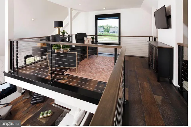 a kitchen view with wooden floor and stainless steel appliances