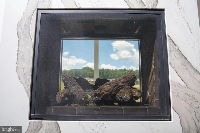 a closeup of a fireplace with a view of a living room