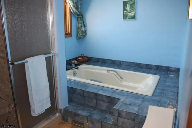 a bathroom with bathtub and window