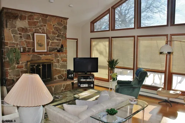 a living room with furniture a fireplace and a flat screen tv