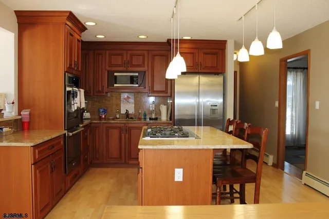 a kitchen with a counter top space appliances and cabinets