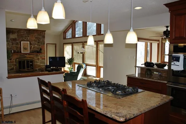 a kitchen with a stove and a dining table