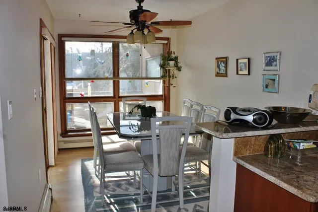 a table and chairs in a kitchen next to a window