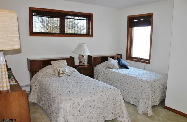 a bedroom with two beds and a window