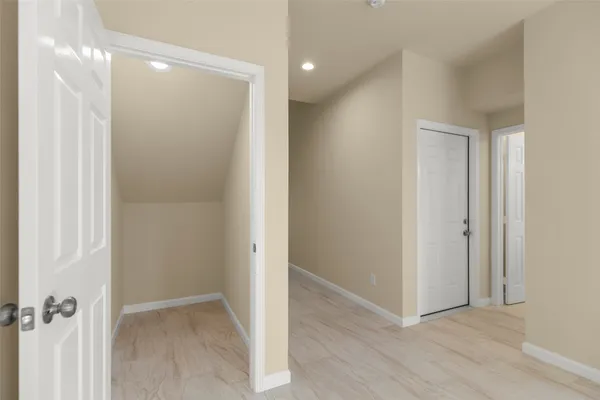 a view of a hallway with wooden floor