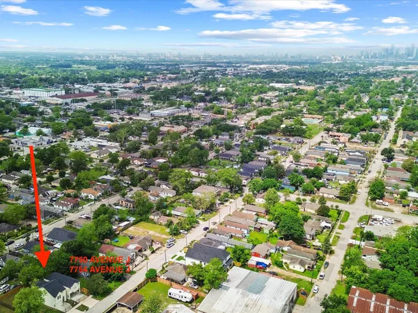 an aerial view of residential houses with outdoor space and street view