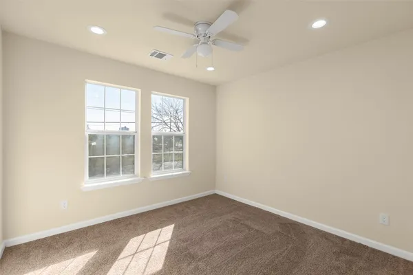 an empty room with windows and closet