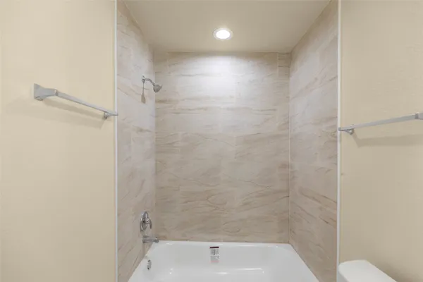 a bathroom with a shower and toilet