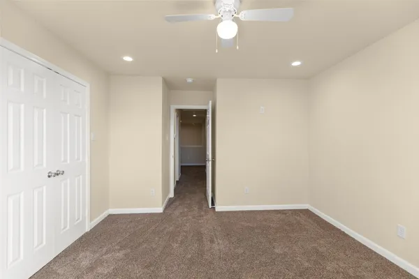 an empty room with a empty space and a ceiling fan