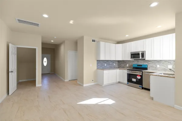 a view of a kitchen with electric appliances