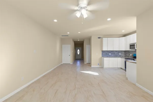 a view of a kitchen with a sink and a refrigerator