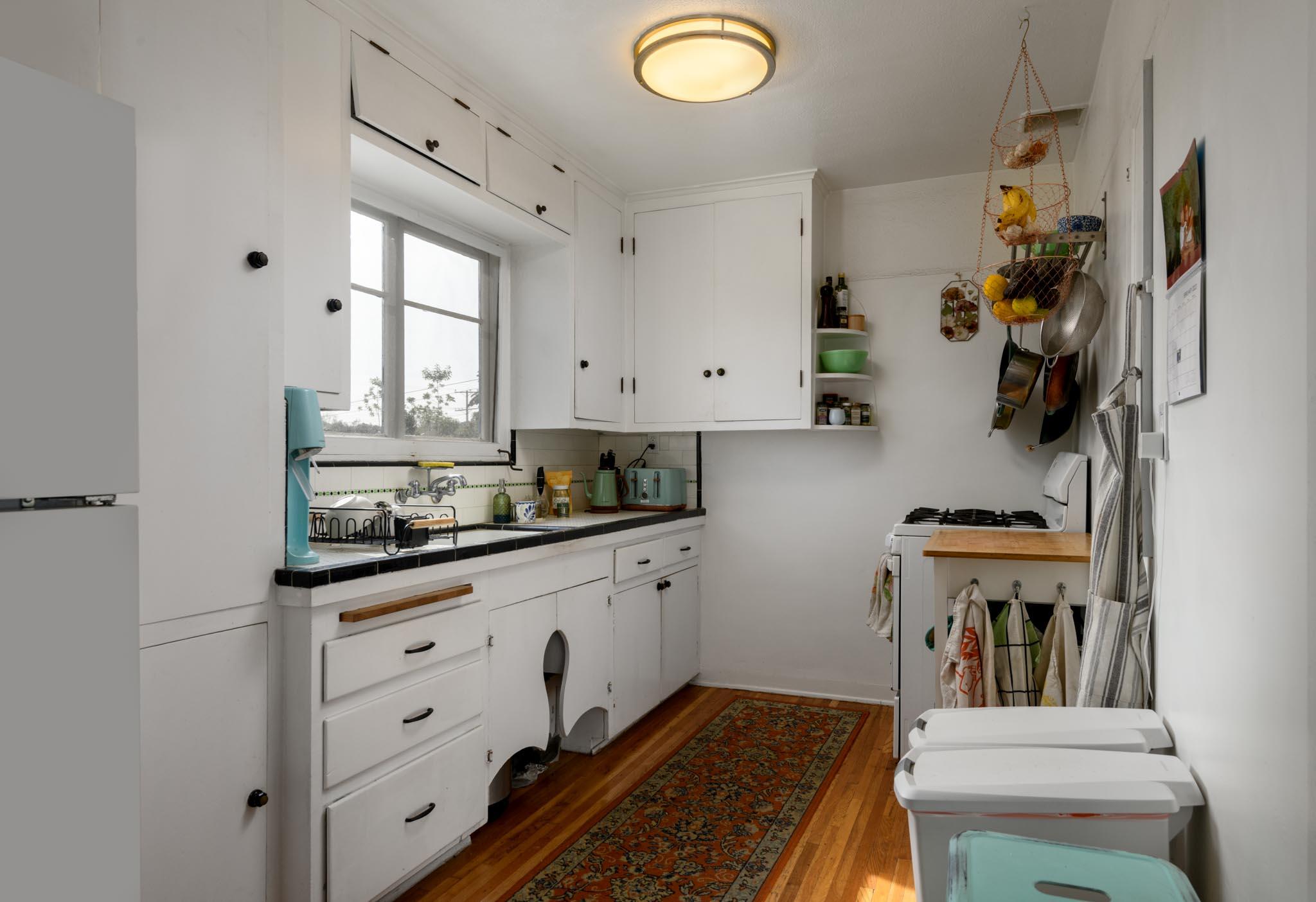 1917 Bath Street Santa Barbara, CA 93101 - Photo 19 of 22 a kitchen with granite countertop a sink a stove and cabinets