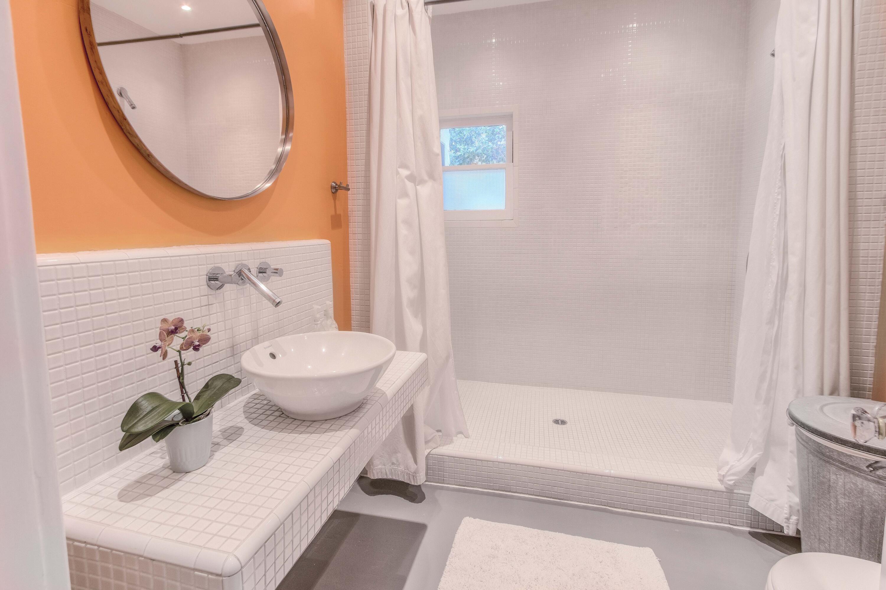 1917 Bath Street Santa Barbara, CA 93101 - Photo 10 of 22 a bathroom with a bath tub and a mirror