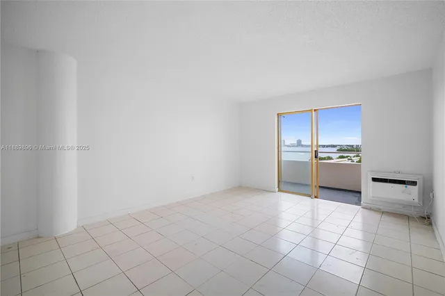 a view of a kitchen with a sink and an empty room