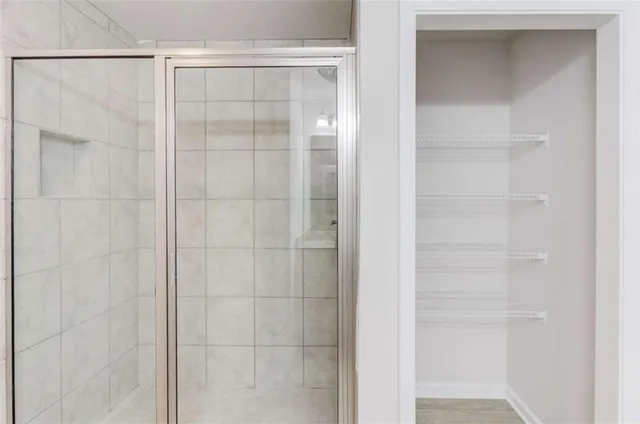 a bathroom with a glass shower door