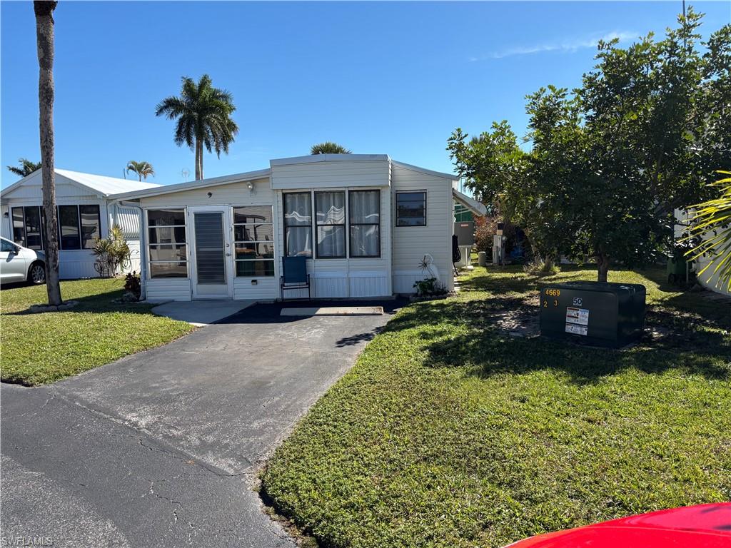 9 Jade Drive, Unit 9J Naples, FL 34114 - Photo 1 of 28 a view of a house with a yard and tree s