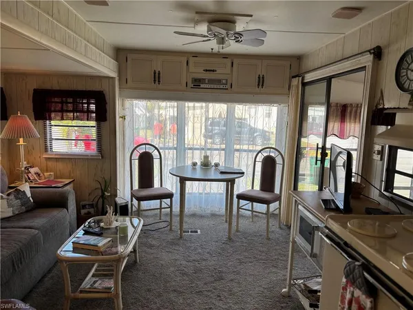 a view of a livingroom with furniture and a window